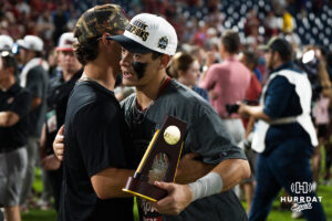 Oklahoma Sooners Kyle Branch (6) hugs his brother after a CWS game on June 22, 2026, in Omaha, Nebraska. Photo by Brandon Tiedemann.