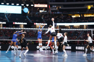 Teraya Sigler (11) takes a swing against Florida in the Spikes Under the Lights exhibition tournament. The sophomore led Nebraska in kills in both matches. Photo by Katie Trout.