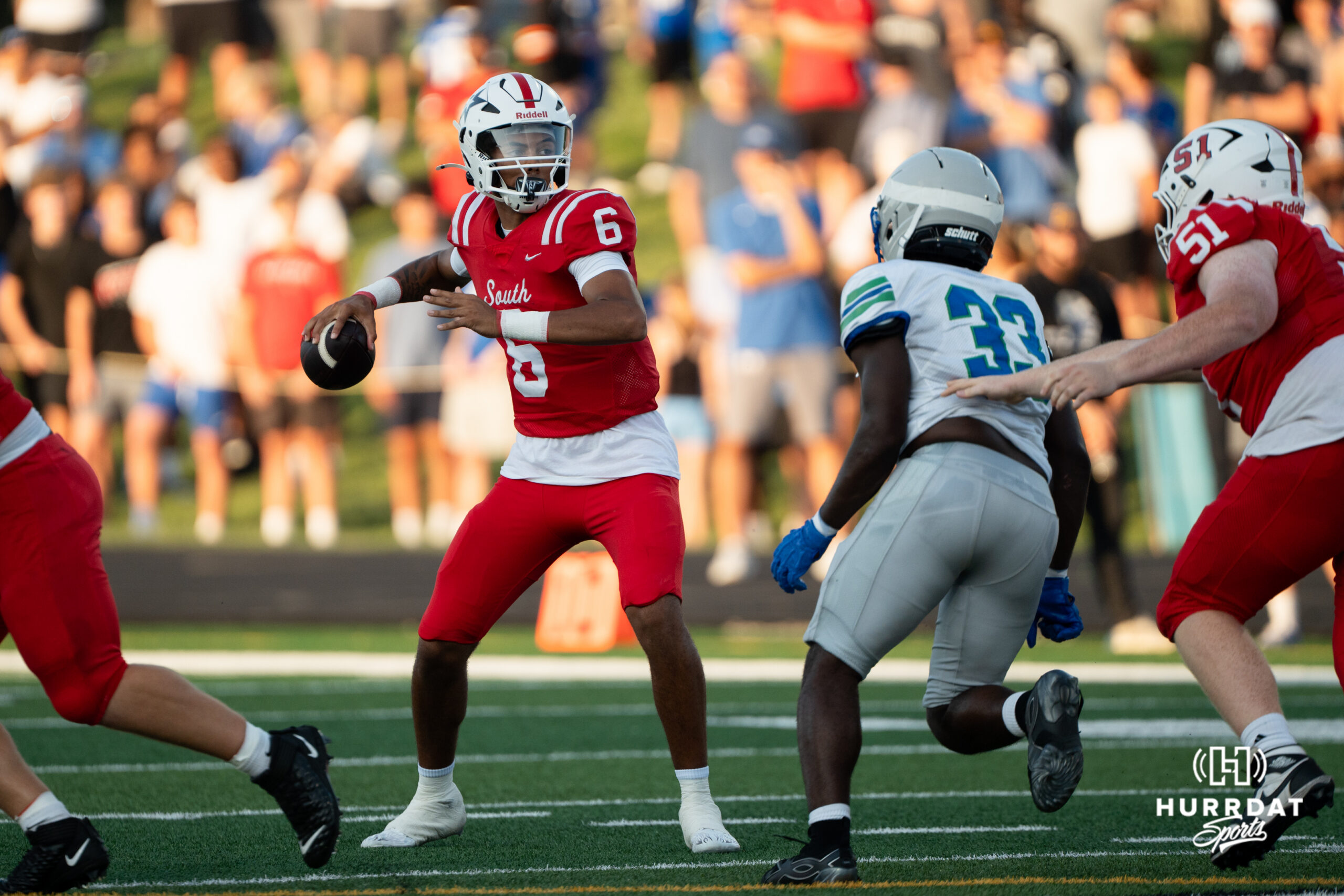 Millard South's Trae Taylor prepares to throw a pass against Millard North