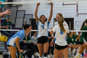 Elkhorn North senior Reagan Wallraff (9) celebrates with her teammates after a point during the Thunderbird Throwdown championship. Photo by Jandi Green.