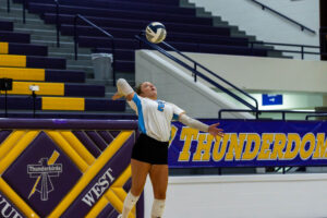Elkhorn North senior Millie Mauch prepares to serve during the Thunderbird Throwdown championship. Photo by Jandi Green.