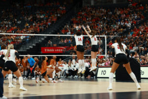 Manaia Ogbechie (14) and Bergen Reilly (2) elevate for a block, one of 10 stuffs for Nebraska against Texas in the Players Era Showcase. Photo by Sean Jorgensen.