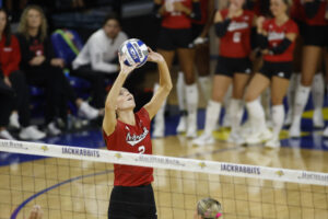 South Dakota native Bergen Reilly sets the ball for No. 1 Nebraska volleyball against South Dakota State in Brookings. Photo by John S. Peterson.