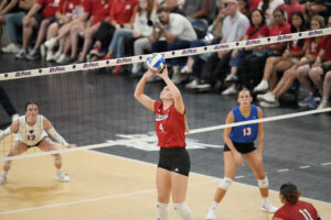 Campbell Flynn sets the Nebraska offense during her season debut. Photo by Kayla Wolf.