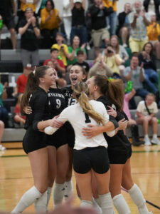Skutt Catholic volleyball celebrates a point in a 3-0 win over Lincoln Pius X. The victory was the 500th for coach Renee Saunders with the SkyHawks. Photo by Mike Sautter.