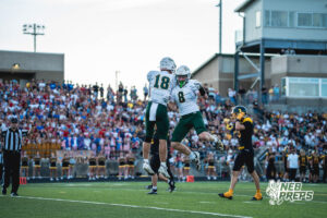 Henry Hildebrand (18) and Nolan Spencer (8) celebrate during a high school football game Friday, September 11, 2026, in Gretna, Nebraska. Photo by Robert Olvera