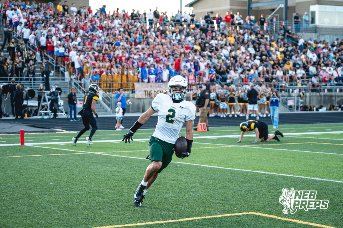 Talon Daharsh (2) runs to celebrate after scoring in front of the Gretna East student section during a high school football game between the Griffins and Dragons Friday, September 11, 2026, in Gretna, Nebraska. Photo by Robert Olvera