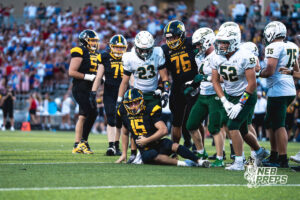 Jack Huttman (23) attempts to help the QB Chase Grow up after he's taken hard hits all night during a high school football game between the Griffins and Dragons Friday, September 11, 2026, in Gretna, Nebraska. Photo by Robert Olvera