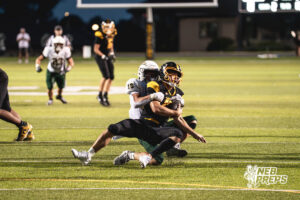 Henry Hildebrand (18) sacks the quarterback during a high school football game between the Griffins and Dragons Friday, September 11, 2026, in Gretna, Nebraska. Photo by Robert Olvera