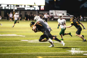 Liam Jones (13) sacks the Quarterback during a high school football game between the Griffins and Dragons Friday, September 11, 2026, in Gretna, Nebraska. Photo by Robert Olvera