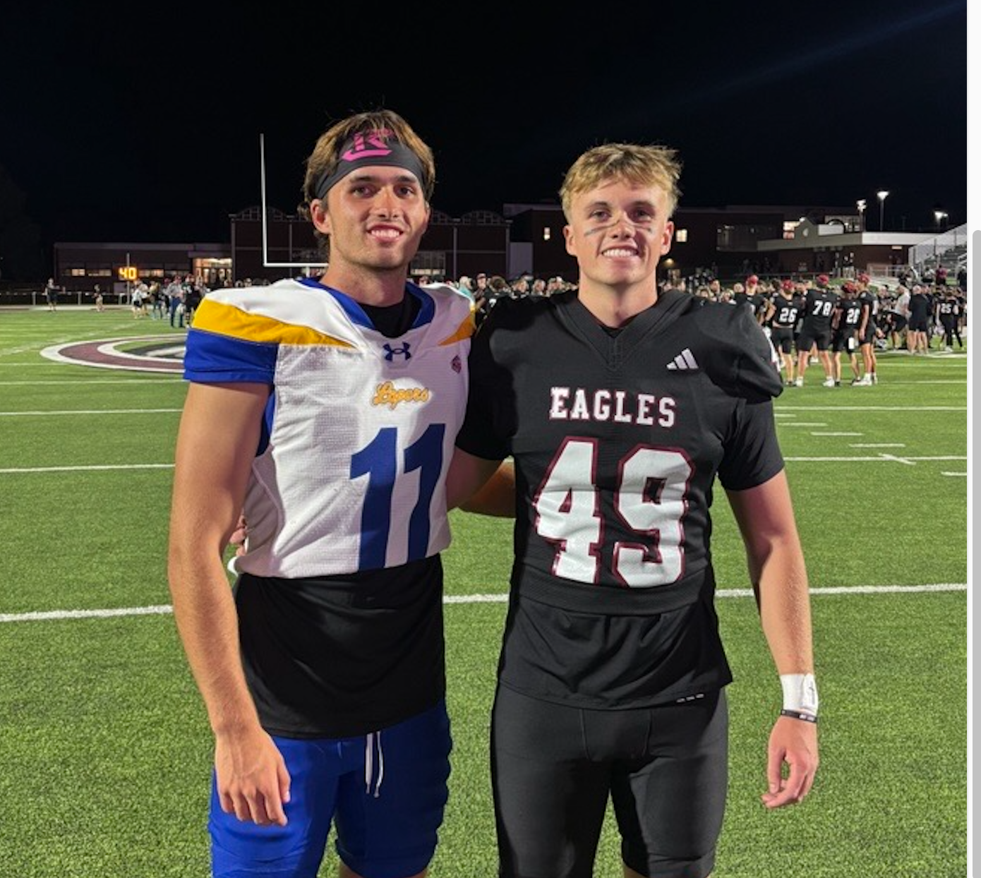 Trey (11) and Shay (49) Prichard pose together after the UNK-Chadron State football game. Photo courtesy Shay Prichard.