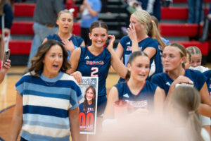 Norris senior Alli Bornschlegl (2) holds a poster commemorating her reaching 1,000 career kills.
