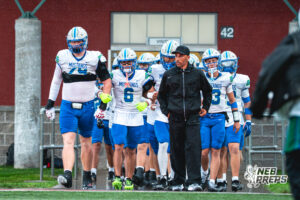 Matt Erickson (79), Kaden Craig (6), Evan Robinson (9), Logan Grosdidier (13), and Head Coach Allen Burrell take the field during a football game against the Lincoln Southwest Silverhawks on September 25, 2026, in Lincoln, Nebraska. Photo by Rob Olvera.
