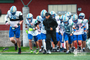 Matt Erickson (79), Kaden Craig (6), Evan Robinson (9), Logan Grosdidier (13), and Head Coach Allen Burrell take the field during a football game against the Lincoln Southwest Silverhawks on September 25, 2026, in Lincoln, Nebraska. Photo by Rob Olvera.