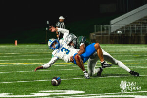 Jase Coke (14) gets a huge hit on Tory Pittman (3) during a football game against the Millard North Mustangs on September 25, 2026, in Lincoln, Nebraska. Photo by Rob Olvera.