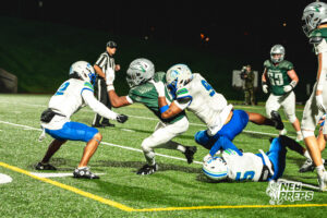 Josiah Wardlow (2) Evan Robinson (9) Jaron Faughn (5) swarm the ball carrier during a football game against the Lincoln Southwest Silverhawks on September 25, 2026, in Lincoln, Nebraska. Photo by Rob Olvera.