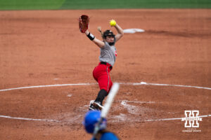 Faith Aragon delivers a pitch in a college softball game.