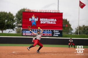 Faith Aragon delivers a pitch in a college softball game.
