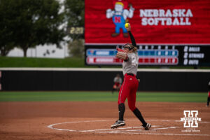 Cali Bentz delivers a pitch in a college softball game.