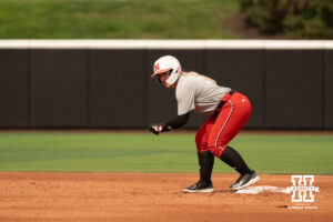 Samantha Bolding leads off second base in a college softball game.