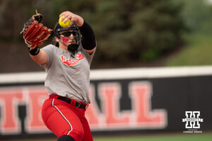 Alexis Jensen delivers a pitch in a college softball game.