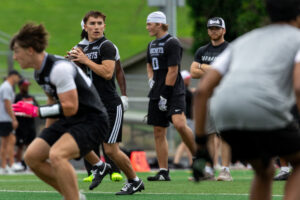 Lincoln Northeast quarterback Zayne Scully drops back to throw the ball at the NebPreps 7v7 State Championship. Photo by Braden Cochran.