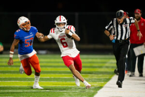 Millard South quarterback Trae Taylor (6) runs the ball up on the sideline for one of his six touchdowns on the day against Omaha Westview. Photo by Jackson D. Luethje.