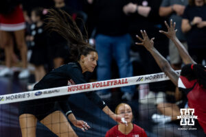 Harper Murray swings over the Wisconsin block for one of her match-high 20 kills. Photo by John S. Peterson.