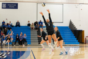 Sami Curnyn sets the ball in a high school volleyball match.