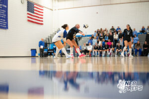 Taylor McLeay passes the ball as Teagan Menicucci backs her up in a high school volleyball match.