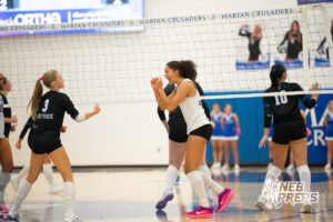 A Papillion-LaVista South player celebrates a point with Katelyn Dyrstad in a high school volleyball match.