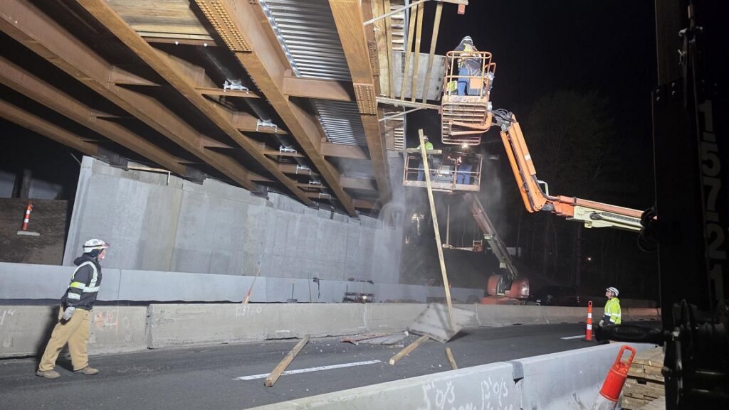 Workers remove under decking on the paddock Avenue Bridge