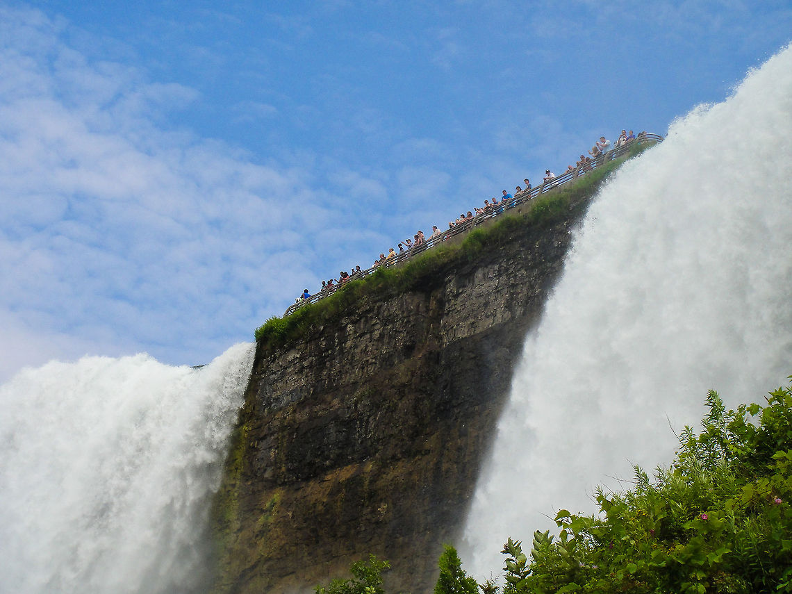 Niagara American and Bridesveil falls Taken from the 'Maid of the Mist' boat. These people are standing right between the 'main' american falls and the smaller bridalveil falls on the right. Canada,Niagara Falls,North America,Waterfall