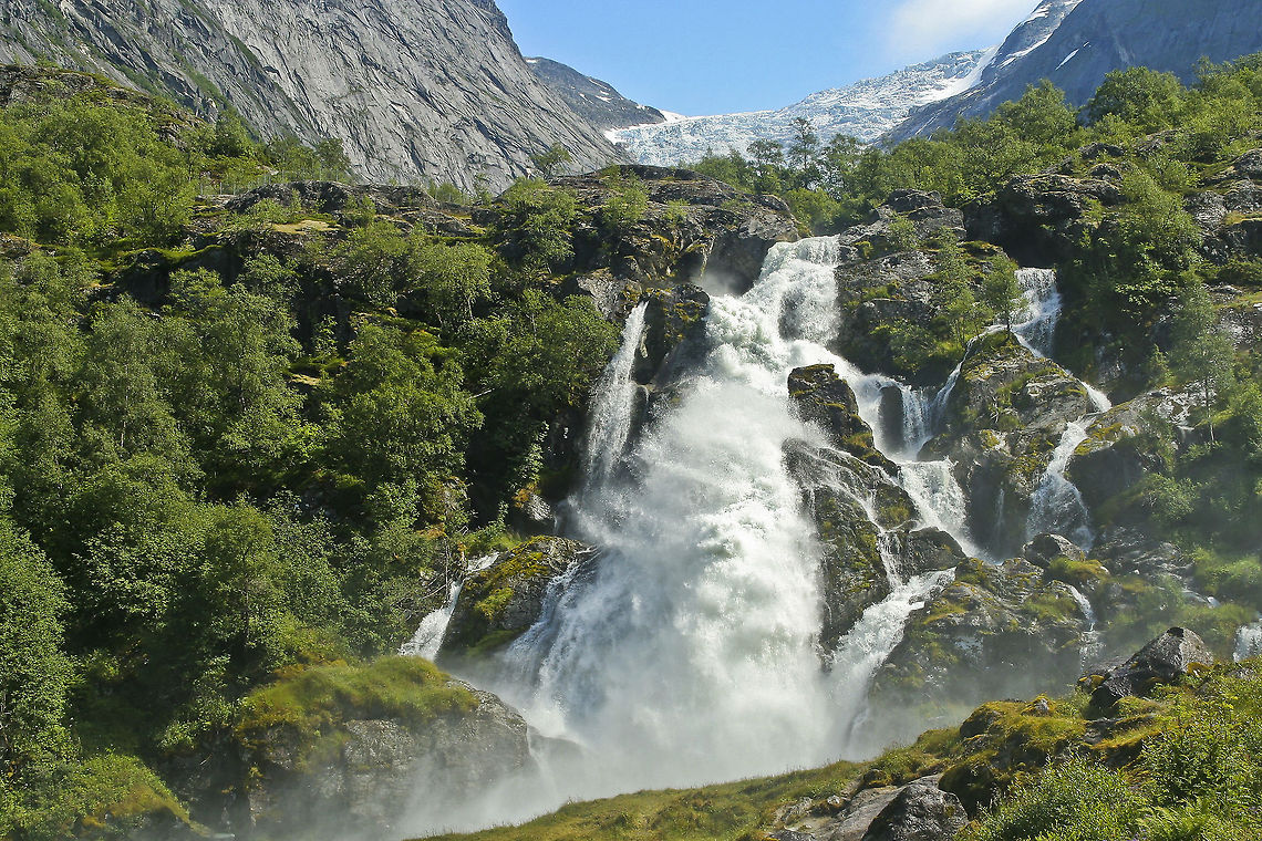 Waterfall in front of glacier This photo shows a waterfall with on the back the jostedal glacier, which is the second largest ice mass in existence in Europe Europe,Glacier,Jostedal,Norway,Waterfall