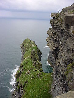 Cliffside portrait This is a portrait view of the Cliffs of Moher, the highest in Europe.The person in the picture is looking down about 214 meters to the ocean Cliffs of Moher,Europe,Ireland