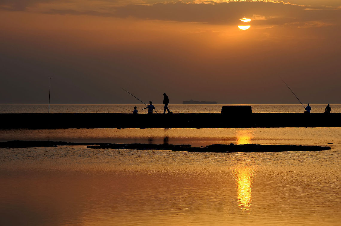 Silhouettes in the Sunset Shadows walking through sewage Sunset