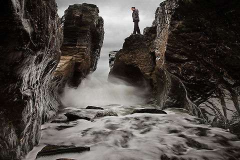 Water-_Carved_Rock_at_Godrevy,_Cornwall This was taken at Godrevy Head, Cornwall, and was rather perilous to make. I opted for a slower shutter speed to blur the water slightly, but not too much as to smooth out the movement too much. My aim was to show the relationship between the concave shapes of the rock and the gushing motion of the water. I made sure to stay fairly close to the water to maintain an in-action perspective, and I didn't mind squelching my way back to the car.  Erosion,Motion,Rushing,Water,coastal,cornwall,godrevy,nature,stone,weathering