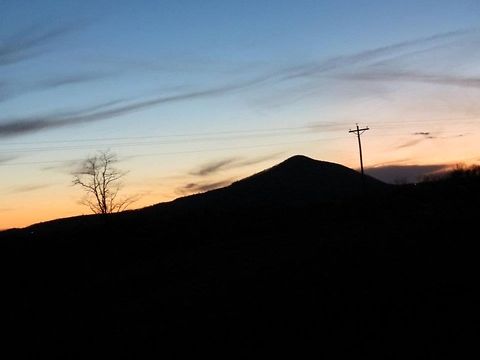 Mountains the silhouette of a mountain at sunset Geotagged,Mountains,Shadows,Sky,Sunset,Tree,United States