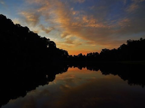 Sunset over the lake this was taken at Tanglewood Park at sunset above the lake Geotagged,Lake,Night,Reflection,Sunset,United States,water