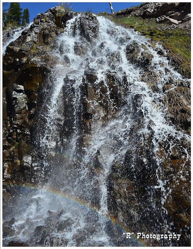 Rainbow Falls The sun casts a rainbow on snow melt water that falls over the ridge in Yellowstone National Park. Geotagged,Natural events,United States,Waterfall,rainbow