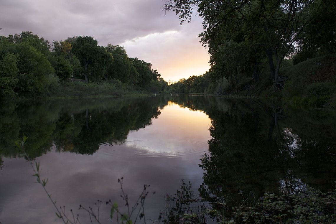 Beautiful Darkness It was during the time of sunset. The sun was already setting, which help create this beautiful colors of purple and red in the clouds. I kept changing the settings constantly until some of the colors of the cloud would be shown clearly in the photo.  Sunset