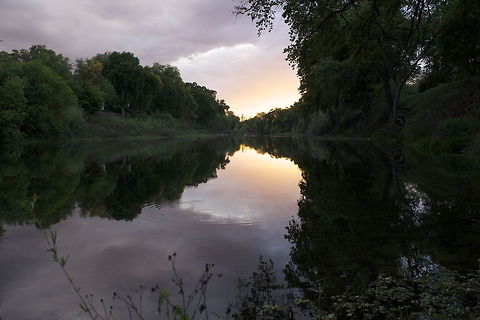 Beautiful Darkness It was during the time of sunset. The sun was already setting, which help create this beautiful colors of purple and red in the clouds. I kept changing the settings constantly until some of the colors of the cloud would be shown clearly in the photo.  Sunset