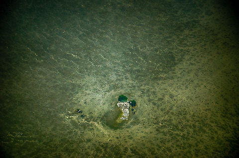 Top view of a "Kopje", Tanzania Aerial shot top view of a kopje, which is an isolated rock formation that appears in an otherwise flat plain. These kopjes play a central role in the Serengeti eco system, being a source of shelter in a very hostile environment. In this photo I tried to highlight how much of a safe haven it is, with nowhere else to hide anywhere near. Africa,Serengeti North,Serengeti area,Tanzania