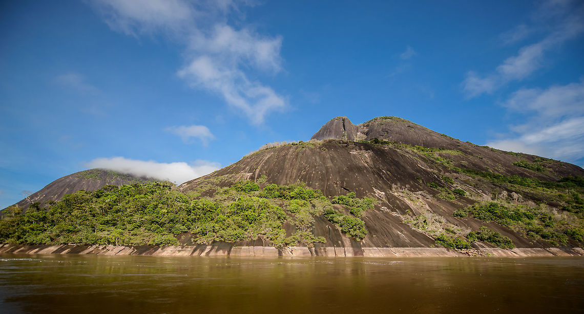 Cerros de Mavecure - ground level, Inírida, Colombia Ground level shot of Cerros de Mavecure, a geological site in Colombia only accessible by boat, consisting of 3 mountains rising up from the Amazon. This is a stitched panorama to fit in both Mono (Monkey, 480m) and Pajarito (Little Bird, 712m).  Colombia,Guainía,Inírida,South America,World