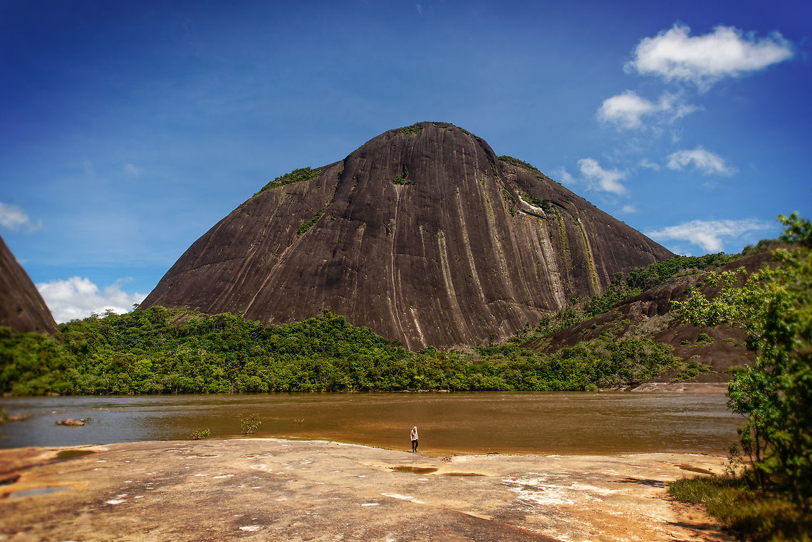 Cerros de Mavecure - size reference, Inírida, Colombia I normally discourage people in photos on JungleDragon, but making an exception here to showcase the size of these Cerros de Mavecure mountains. It also shows how my 14-24 ultra wide angle was much needed to take in the whole site:<br />
<figure class="photo"><a href="https://www.jungledragon.com/image/53279/cerros_de_mavecure_inrida_colombia.html" title="Cerros de Mavecure, In&iacute;rida, Colombia"><img src="https://s3.amazonaws.com/media.jungledragon.com/images/2/53279_thumb.jpg?AWSAccessKeyId=05GMT0V3GWVNE7GGM1R2&Expires=1759968010&Signature=J%2FOh3ybSTMI9mD2n4k%2FOg8pNbZs%3D" width="200" height="142" alt="Cerros de Mavecure, In&iacute;rida, Colombia This unique geological scene is a two hour boat fare away from the In&iacute;rida port. On this day, we were the first to arrive, having it all to ourselves. The site is bizarre and consists of 3 mountains that seem to appear out of nowhere in a surrounding environment that is almost entirely flat for hundreds of miles.<br />
<br />
We had to climb up on the other side to get this overview shot, which shows on the left the mountain Mono (Monkey, 480m) and on the right Pajarito (Little Bird, 712m).<br />
<br />
Ground level panorama:<br />
https://www.jungledragon.com/image/53280/cerros_de_mavecure_-_ground_level_inrida_colombia.html<br />
<br />
Behind us:<br />
https://www.jungledragon.com/image/53282/cerros_de_mavecure_-_opposite_side_inrida_colombia.html<br />
<br />
Foggy top of &quot;Little Bird&quot;:<br />
https://www.jungledragon.com/image/53283/cerros_de_mavecure_-_cerro_pajarito_inrida_colombia.html<br />
https://www.jungledragon.com/image/53284/cerros_de_mavecure_-_cerro_pajarito_foggy_inrida_colombia.html<br />
<br />
&quot;Monkey&quot; from ground level:<br />
https://www.jungledragon.com/image/53285/cerros_de_mavecure_-_cerro_mono_inrida_colombia.html<br />
https://www.jungledragon.com/image/53287/cerros_de_mavecure_-_cerro_mono_inrida_colombia.html<br />
<br />
&quot;Monkey&quot; from water:<br />
https://www.jungledragon.com/image/53288/cerros_de_mavecure_-_cerro_mono_from_water_inrida_colombia.html<br />
<br />
Another ground level panorama:<br />
https://www.jungledragon.com/image/53286/cerros_de_mavecure_-_cerro_mono_and_cerro_pajarito_inrida_colombia.html<br />
<br />
Size reference:<br />
https://www.jungledragon.com/image/53289/cerros_de_mavecure_-_size_reference_inrida_colombia.html Colombia,Guain&iacute;a,In&iacute;rida,South America,World" /></a></figure> Colombia,Guainía,Inírida,South America,World