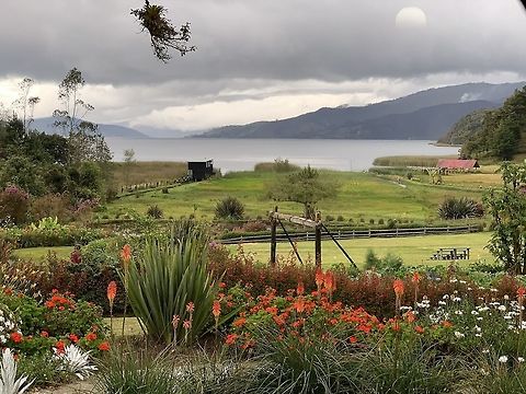 Laguna de la Cocha, Colombia I know the scene isn't entirely natural with the botanical garden in front, but this marks the end of our travel day where we arrive at a new site: Laguna de la Cocha, which sits at about 3,000m asl. The lake in front is the actual lagoon, a volcanic crater lake that is part of the Amazon basin and outflows into these rivers: Guamu&eacute;s River, Putumayo River.

Those rivers, are the rivers that enclose La Isla Escondida:

https://www.jungledragon.com/tag/50999/la_isla_escondida.html

...which sits at 850m asl. They start here. We had no idea about this connection.

All the way to the right in the lake itself you see the beginning of a small island. This is Isla de la Corota, Colombia's smallest national park. 

Given the altitude, the weather here is foggy and cold. At night, temperatures may be sub zero, and early mornings are still freezing. Mid day, temperatures were around 10-15C. Quite a departure from the lower altitude jungles we came from.

This area has a surprising Swiss architecture applied, which makes you feel like you're into the Alps.  Colombia,Fall,Geotagged