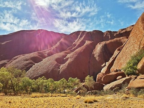 The Beauty of Uluru I was amazed to see so much greenery around Uluru, given that that the usual photos you see depict only red earth. As I hiked around the entire base, I noticed that the rock appeared to be changing colour as a result of the light hitting it as the day wore on.  After spending a solid three hours hiking, I felt truly blessed to have been able to see this magnificent monolith up close and from angles not traditionally seen in photos.  Australia,Geotagged,Landscapes,Uluru