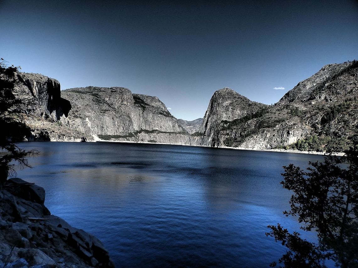 Hetch Hetchy, California Hetch Hetchy is the name of a valley, a reservoir and a water system in California in the United States. The glacial Hetch Hetchy Valley lies in the northwestern part of Yosemite National Park and is drained by the Tuolumne River.   <br />
The photo shows the Hetch Hetchy Valley and the Tuolumne River, looking east. Wapama Falls is on the left, Kolana Rock on the right.  Kolana Rock, at 1,759 m, is a massive rock spire on the south side of the Hetch Hetchy Valley. Hetch Hetchy Dome, at 1,889 m, lies directly north of it. Geotagged,Summer,United States