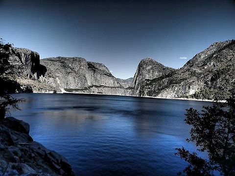 Hetch Hetchy, California Hetch Hetchy is the name of a valley, a reservoir and a water system in California in the United States. The glacial Hetch Hetchy Valley lies in the northwestern part of Yosemite National Park and is drained by the Tuolumne River.   
The photo shows the Hetch Hetchy Valley and the Tuolumne River, looking east. Wapama Falls is on the left, Kolana Rock on the right.  Kolana Rock, at 1,759 m, is a massive rock spire on the south side of the Hetch Hetchy Valley. Hetch Hetchy Dome, at 1,889 m, lies directly north of it. Geotagged,Summer,United States
