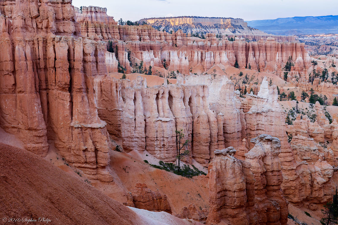 Standing Room Only General Description:<br />
Hoodoos are tall skinny spires of rock that protrude from the bottom of arid basins and "broken" lands. Hoodoos are most commonly found in the High Plateaus region of the Colorado Plateau and in the Badlands regions of the Northern Great Plains. While hoodoos are scattered throughout these areas, nowhere in the world are they as abundant as in the northern section of Bryce Canyon National Park. In common usage, the difference between Hoodoos and pinnacles or spires is that hoodoos have a variable thickness often described as having a "totem pole-shaped body." A spire, on the other hand, has a smoother profile or uniform thickness that tapers from the ground upward. Geotagged,Summer,United States